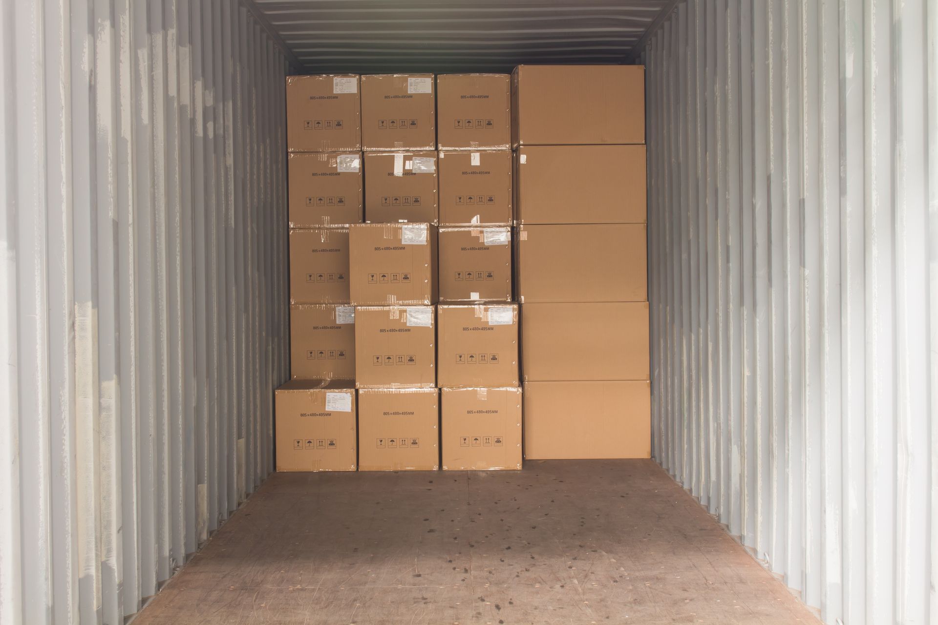 Packed boxes sit inside a portable storage container.