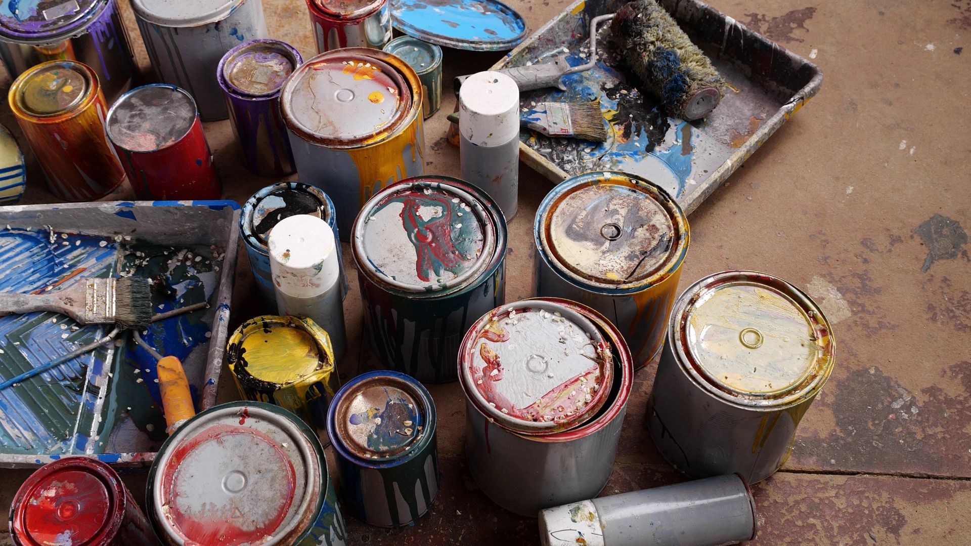 A collection of household hazardous waste paint cans.