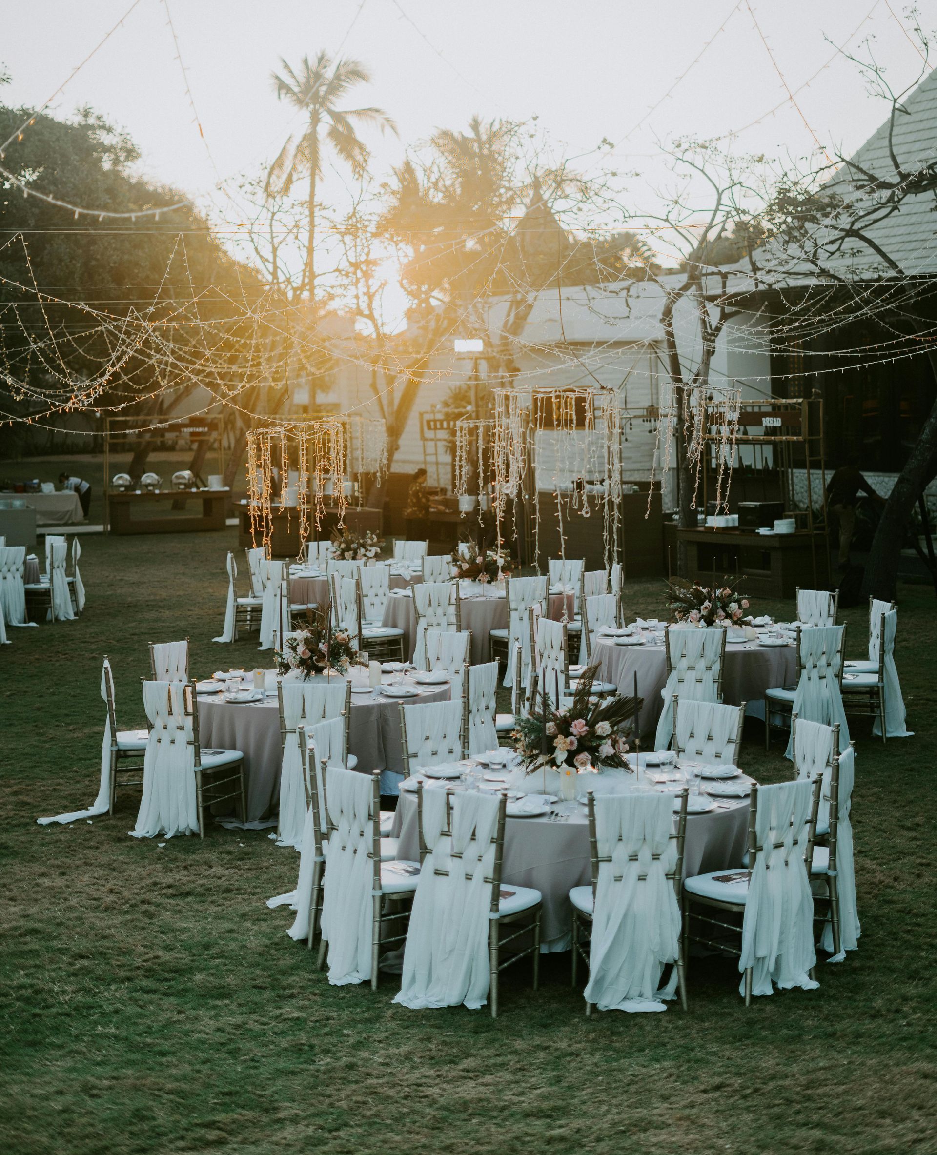 A bunch of tables and chairs set up for a wedding reception