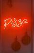 A neon sign that says pizza is hanging on a wall.
