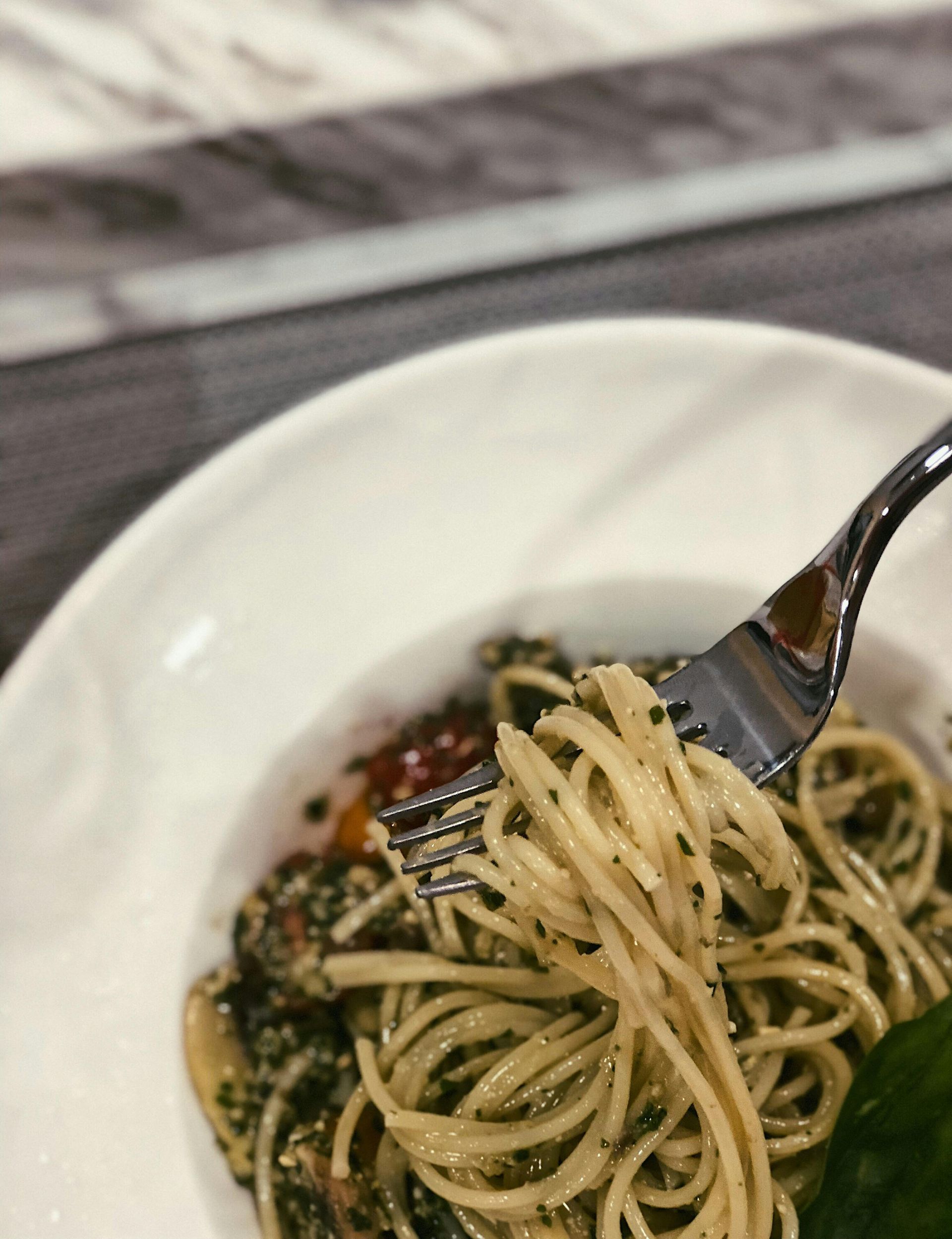 A plate of spaghetti with a fork in it