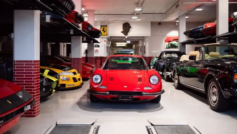 Geneva, Switzerland - 28 September 2023: sports cars including red Ferrari 246 GTS classic supercar on display at a luxury car dealership in suburban Geneva.