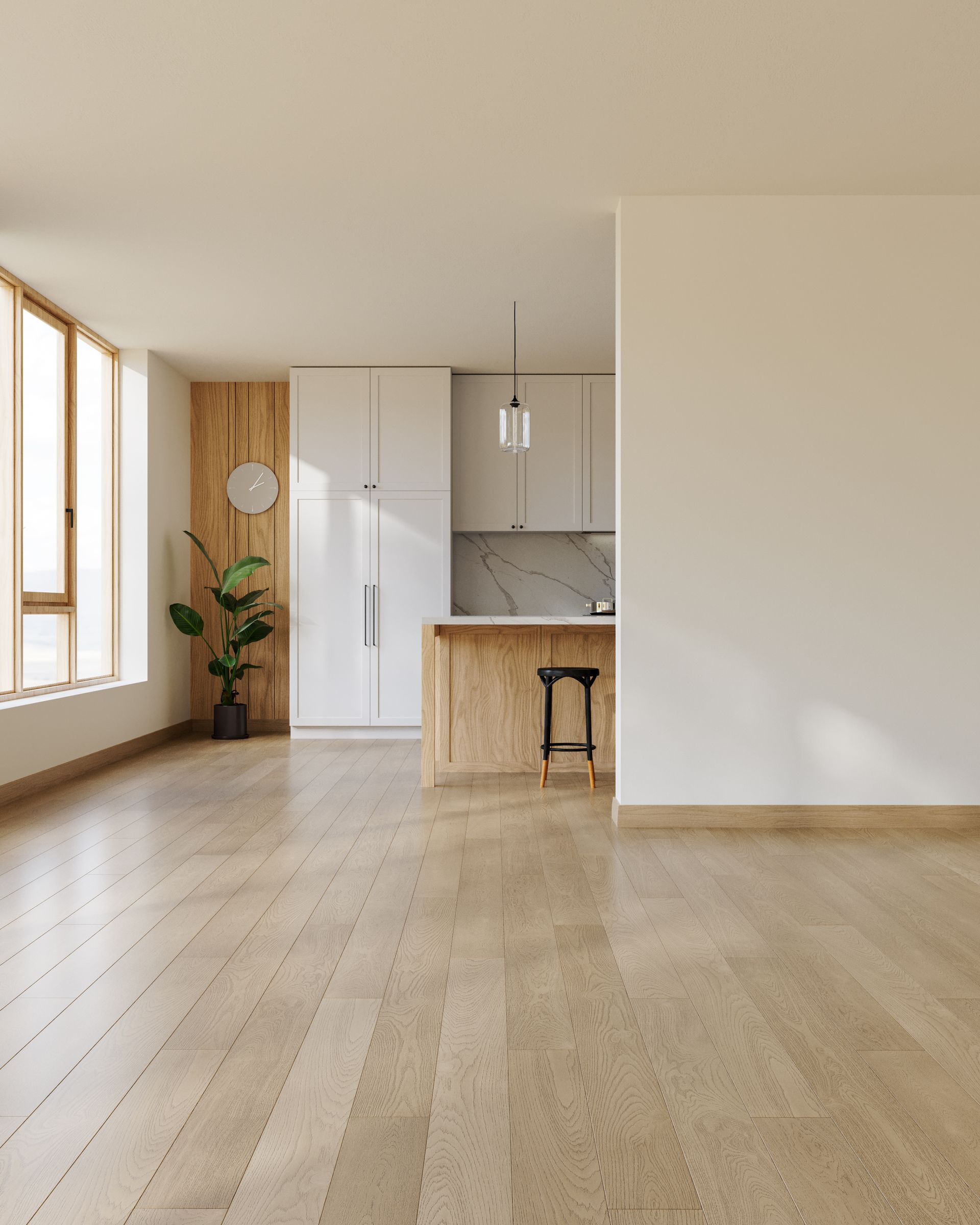 Bright empty modern apartment with wood floors, large windows, and a small kitchen island.