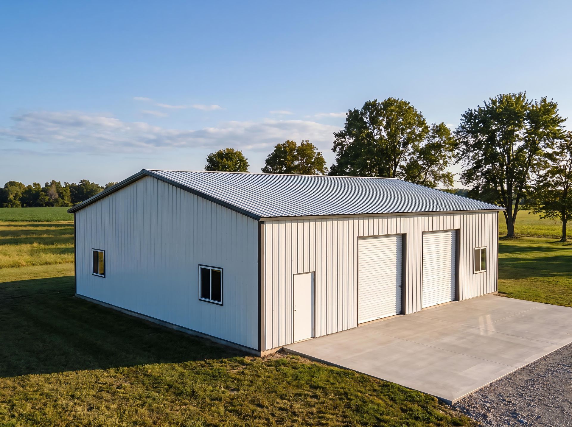 Open-sided wooden barn with a pitched corrugated metal roof and timber posts