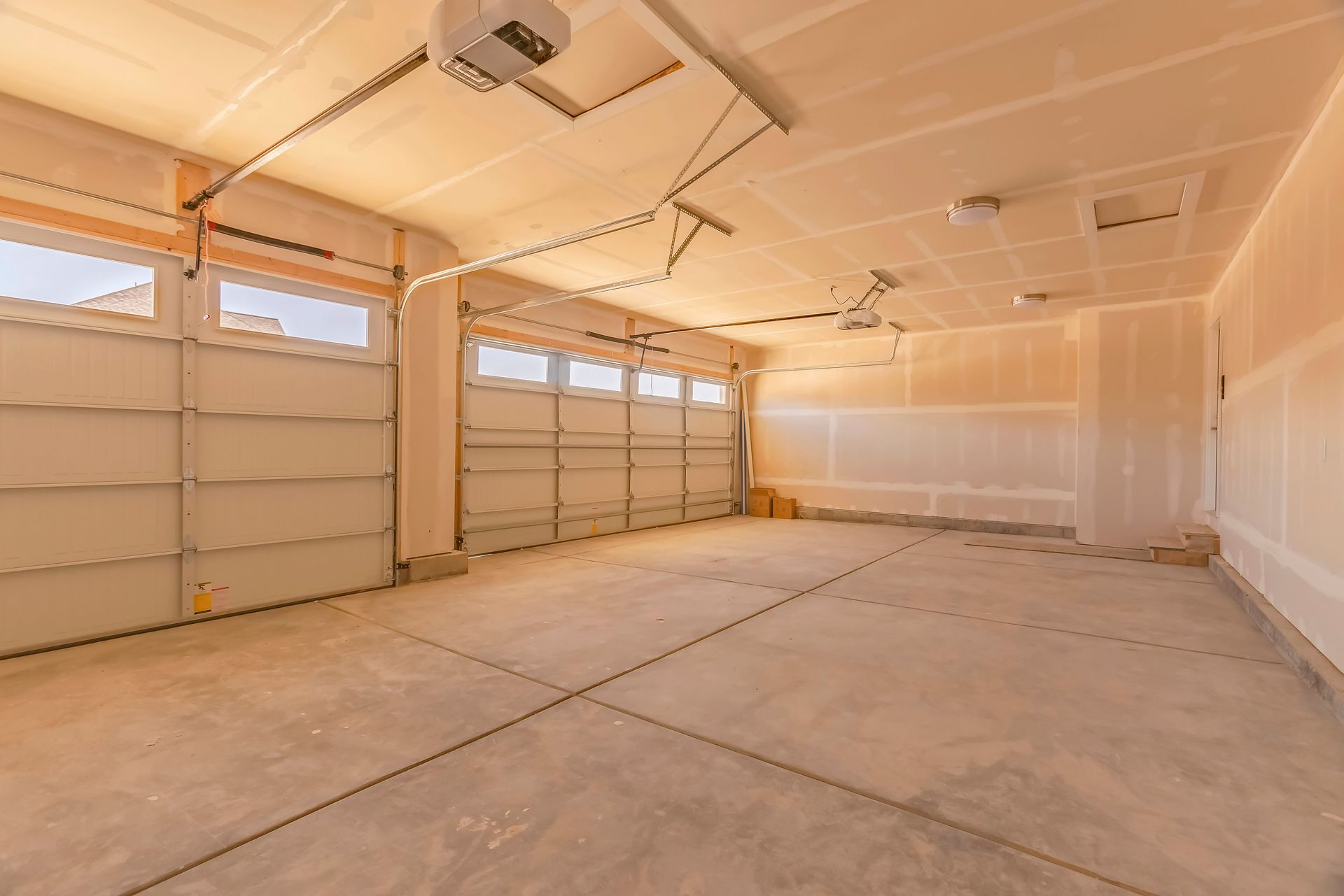 White double garage door with arched windows on a house exterior