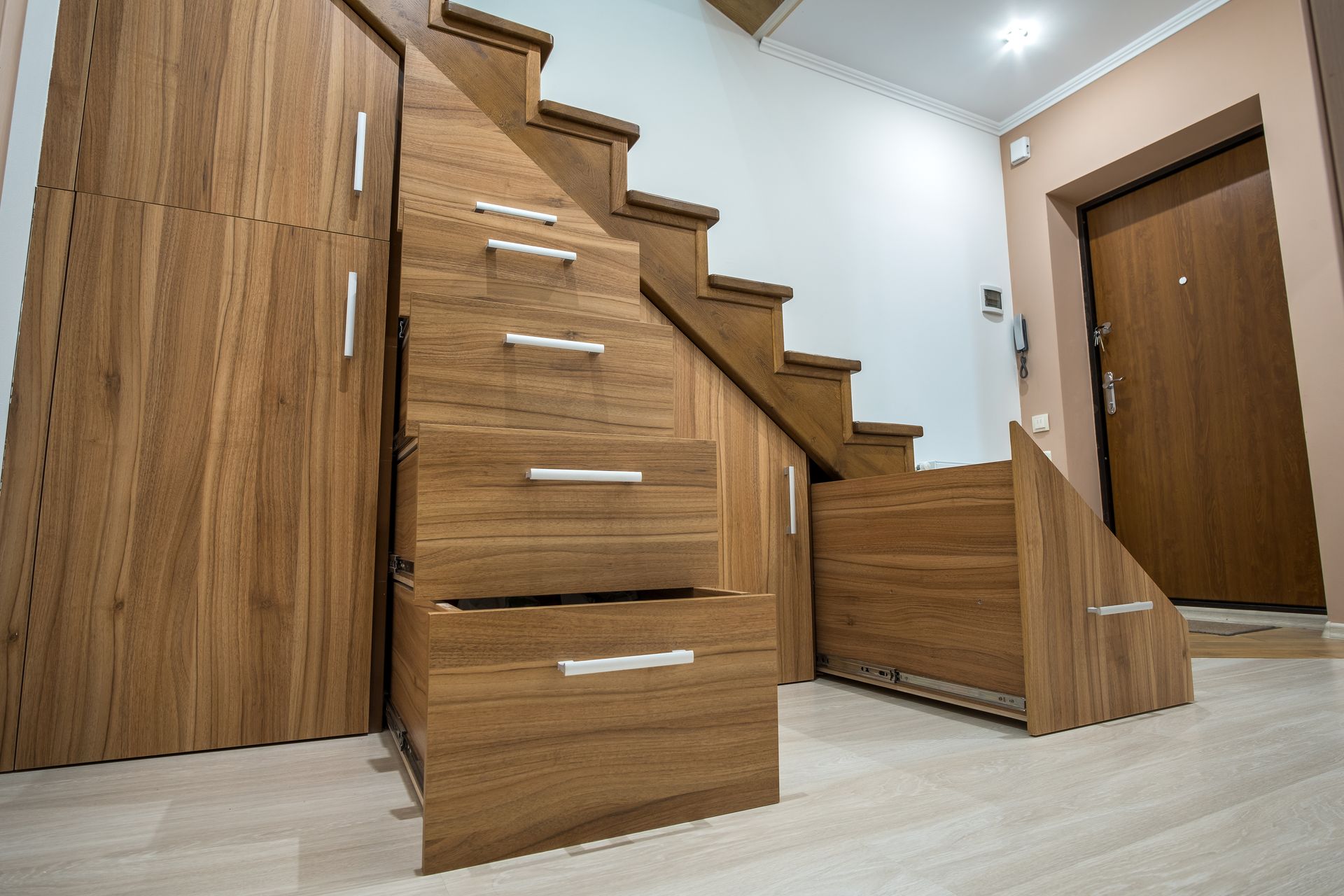 Wooden staircase with built-in storage drawers in a modern hallway