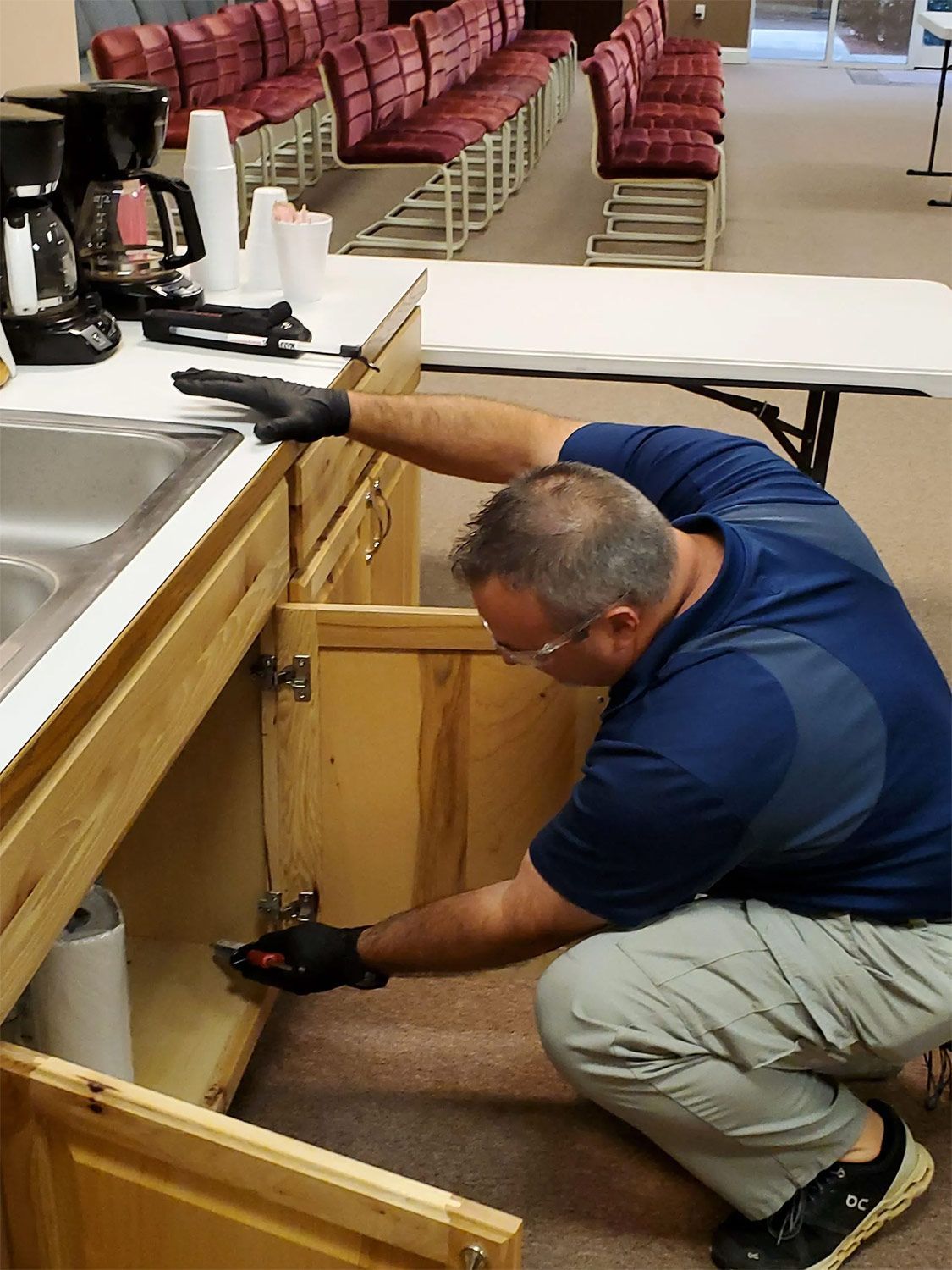 Worker Checking the Cabinets — Gainesville, GA — Duncan Exterminating Co.
