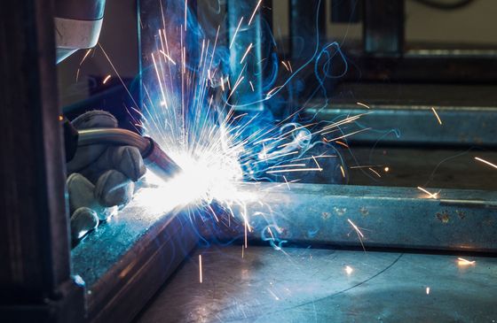 Skilled welder performing precise welding on a metal joint