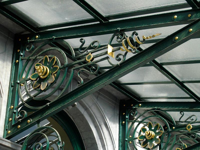 sturdy metal awning framework supporting glass inserts