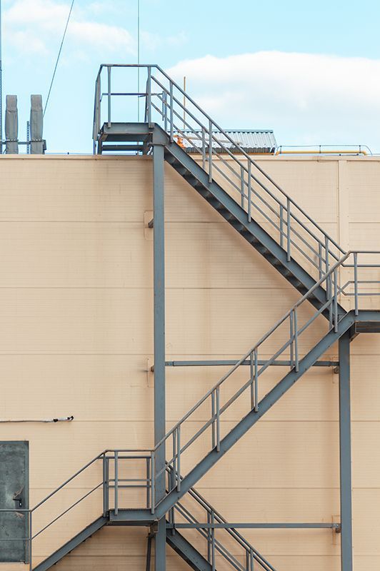 Metal stairs for roof access at different levels