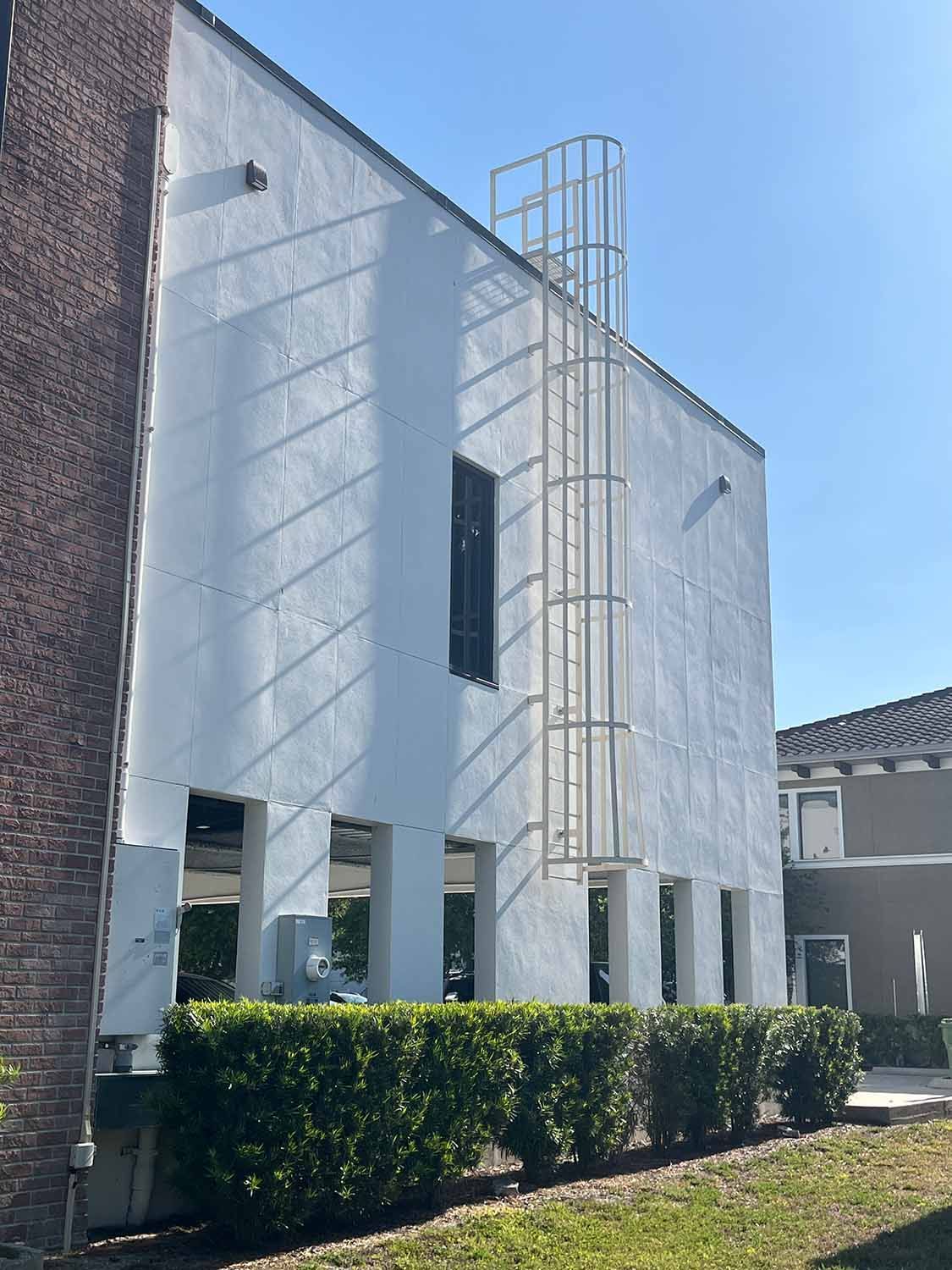 aluminum ladder mounted to commercial building as roof access point