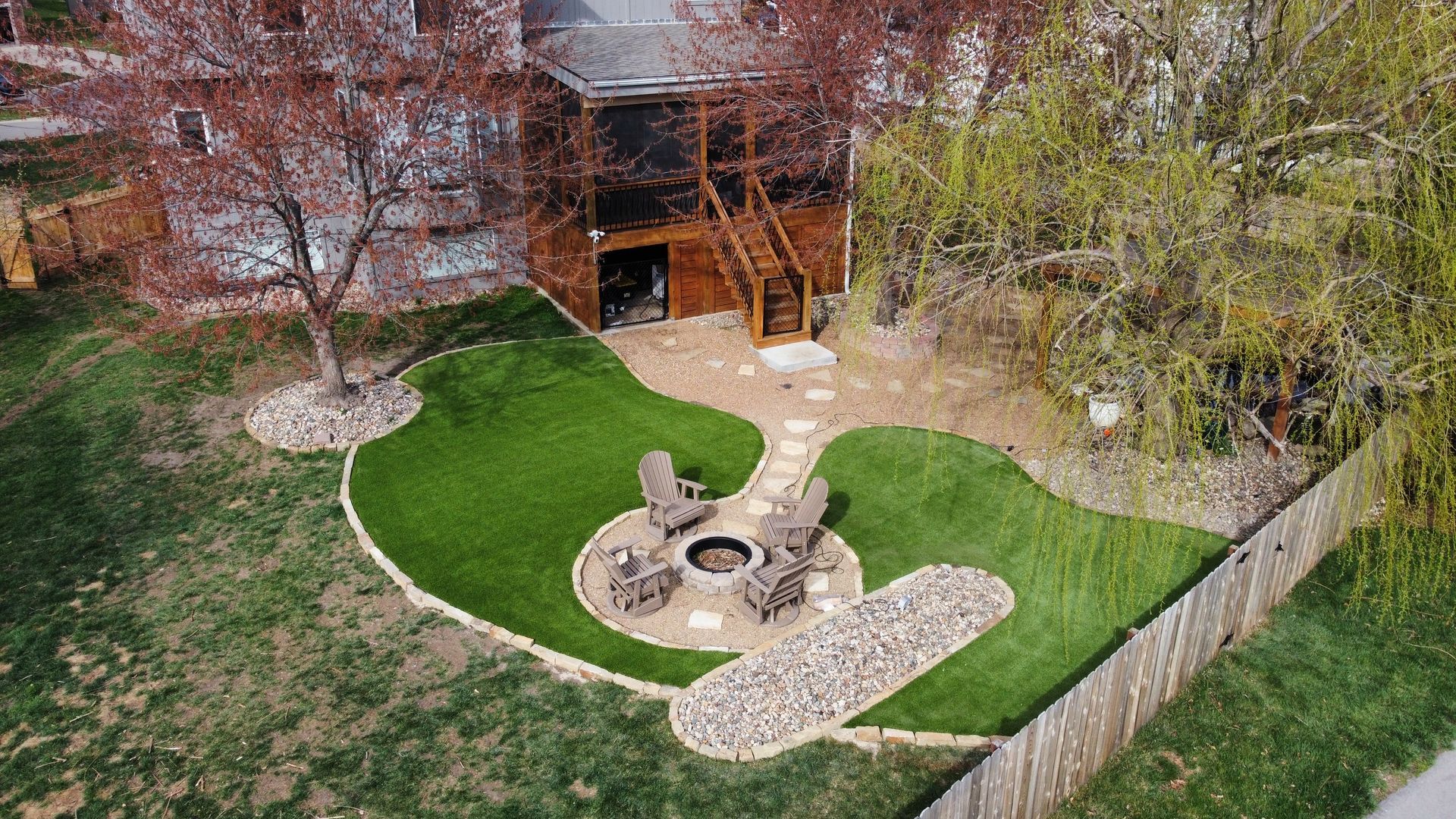 A large swimming pool surrounded by a green artificial turf lawn.
