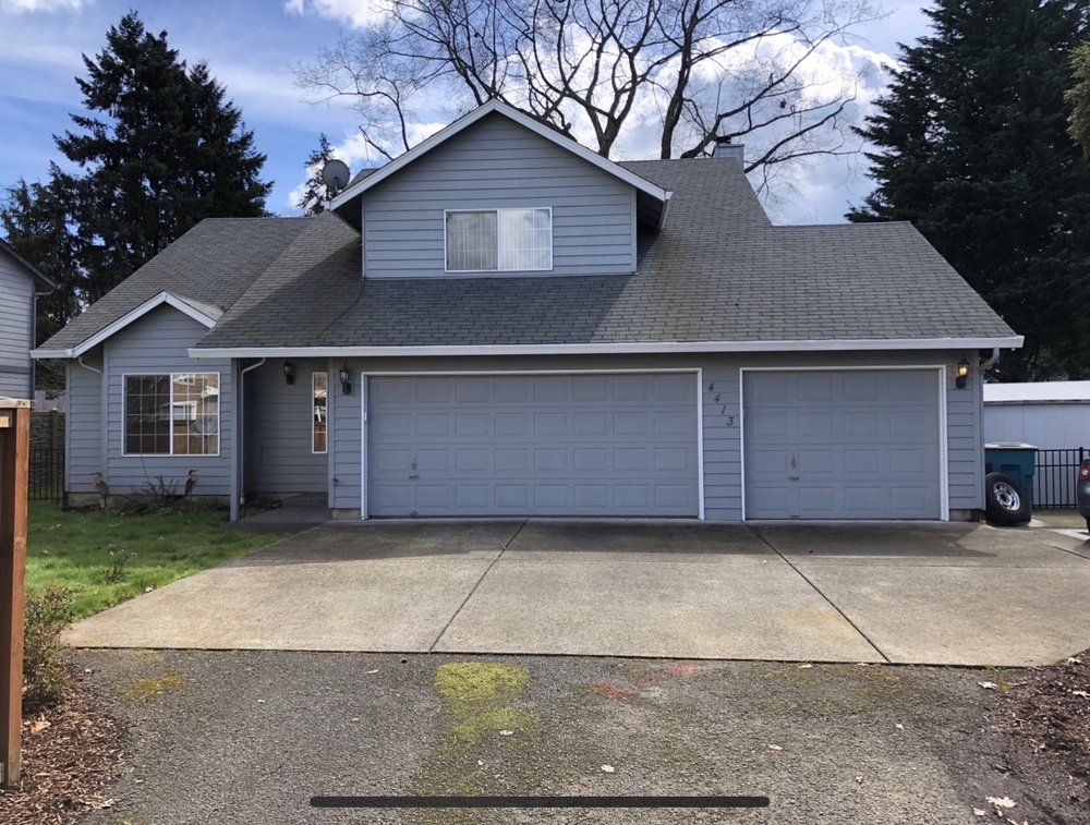 Two-story gray house with a two-car garage and a driveway.