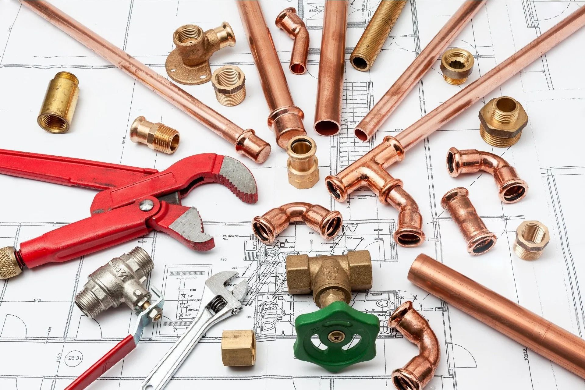 Plumbing Tools and Copper Pipes Arranged on A Blueprint Background — Weav Plumbed in Emerald, QLD