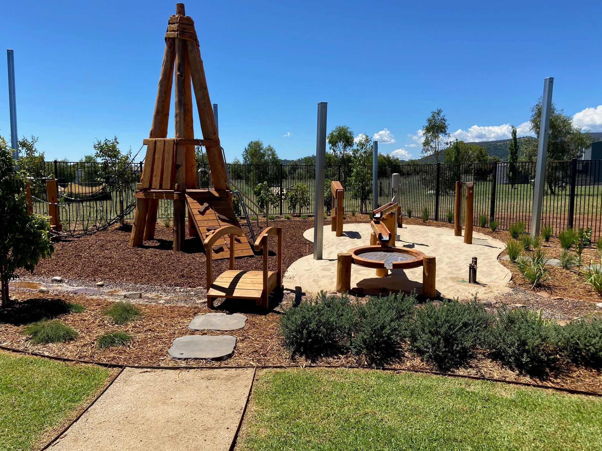 Playground With Wooden Structures, Sand, and Walking Path Under a Clear Blue Sky — ATH Projects in Kirrawee, NSW