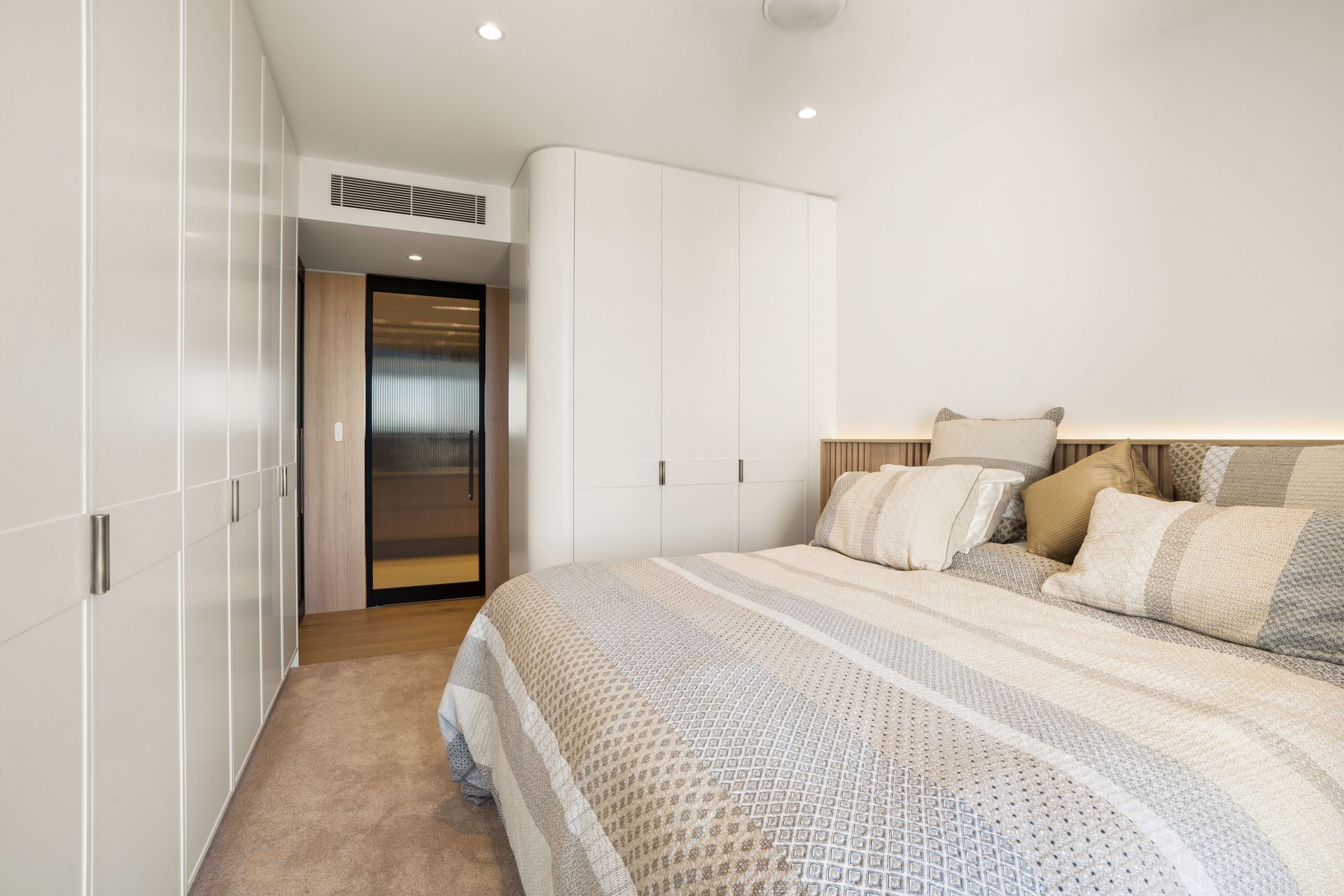 Bedroom With a Bed, White Built-in Closets, and a Small Hallway — ATH Projects in Drummoyne, NSW