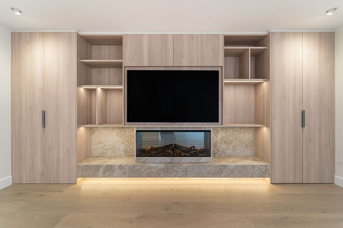 Wooden Cabinet With Television Mounted On It.