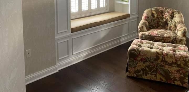 A & R Home Services remodel living room with a chair , ottoman and window seat.