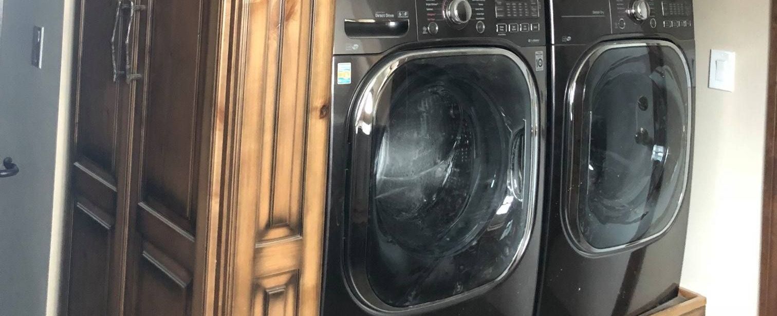 A & R Home Services washer and dryer are sitting next to each other in a laundry room.