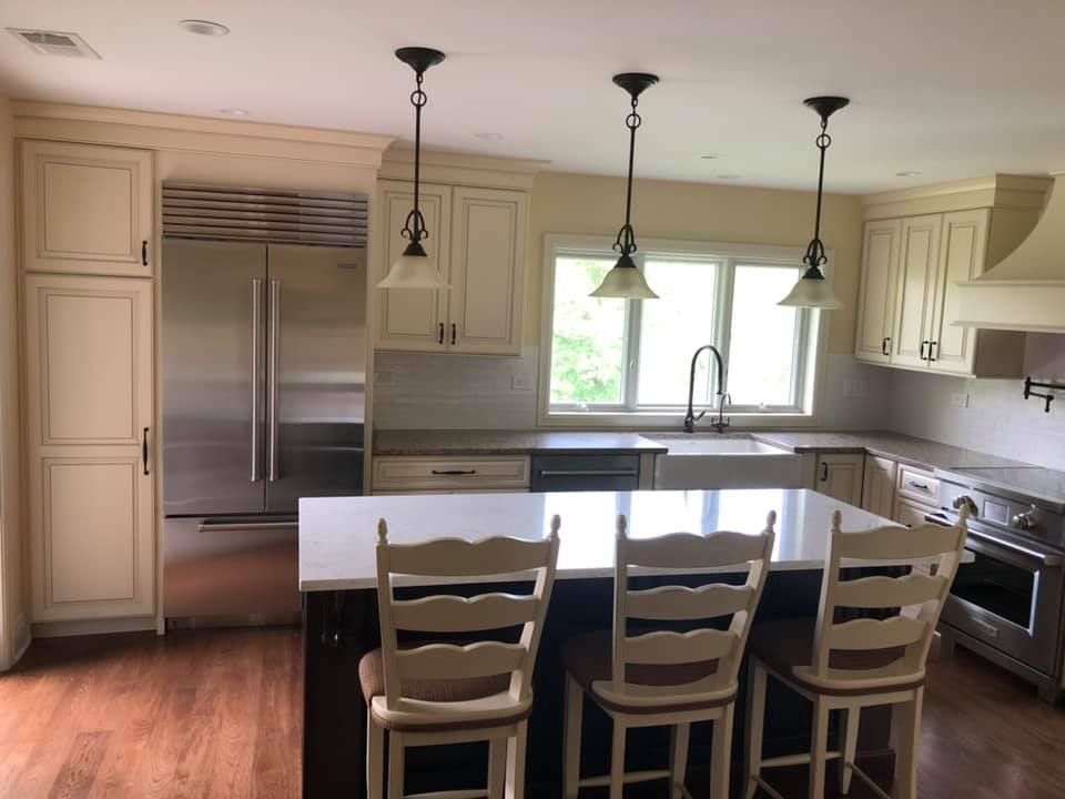 A & R Home Services remodel kitchen with white cabinets and stainless steel appliances