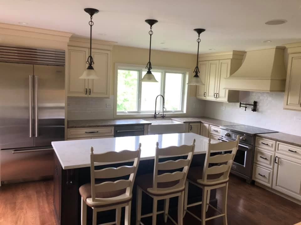 A & R Home Services remodel kitchen with white cabinets and stainless steel appliances