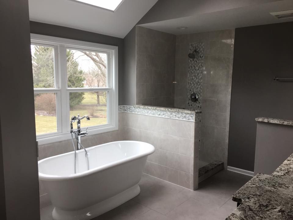 A & R Home Services remodel bathroom with a bathtub and a walk in shower.