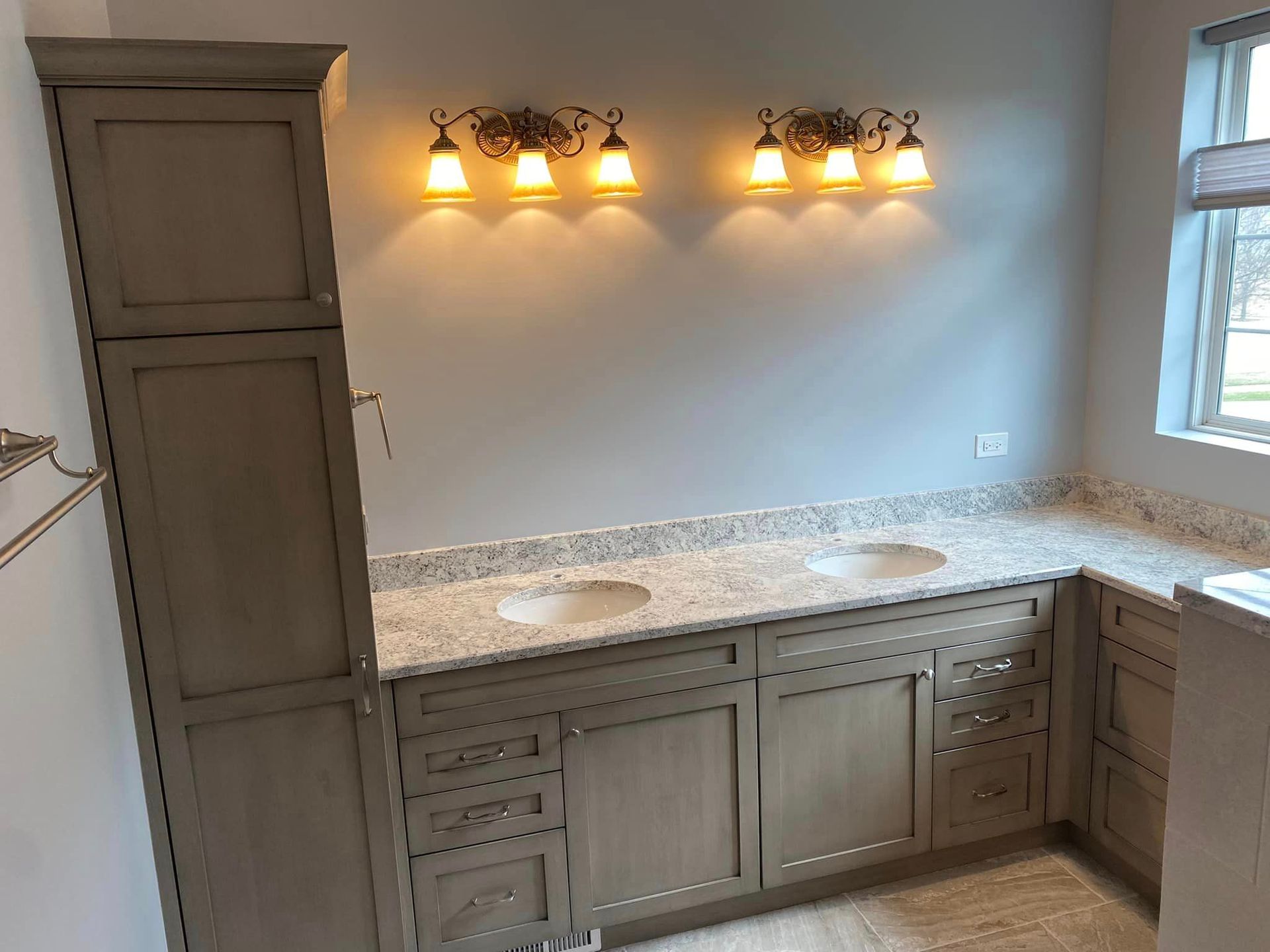A & R Home Services remodel bathroom with two sinks , a cabinet , and a window.