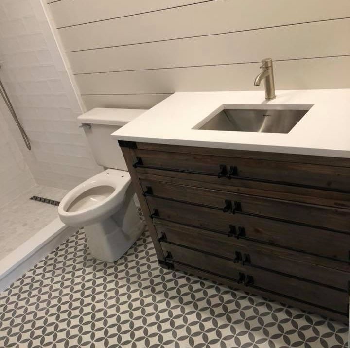 A & R Home Services remodel bathroom with a toilet a sink and a dresser