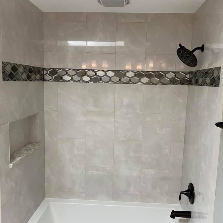 A & R Home Services remodel bathroom with a bathtub and a shower head.