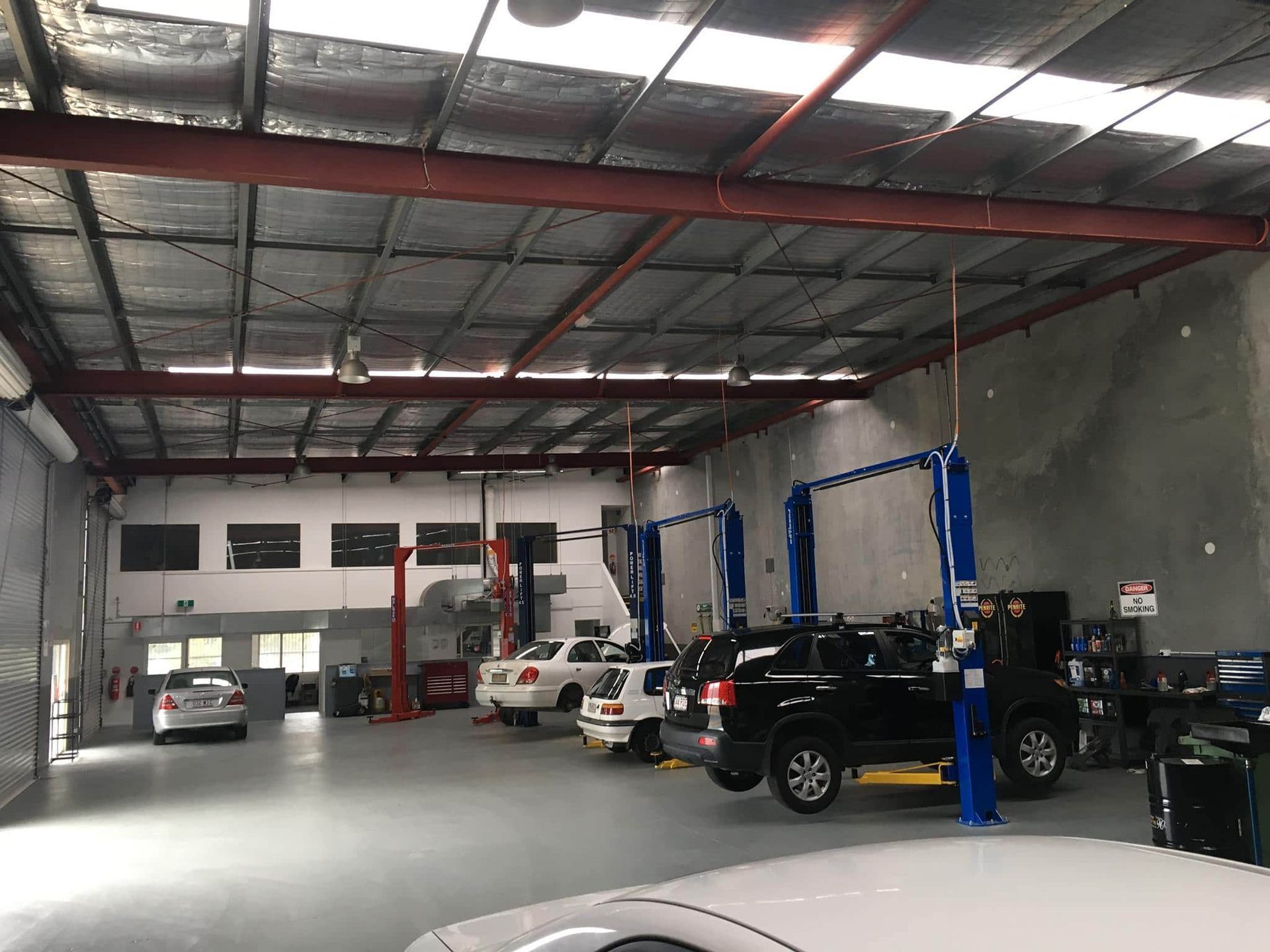 A row of cars are parked inside of a garage. β Carite Auto Repairs In Warana, QLD