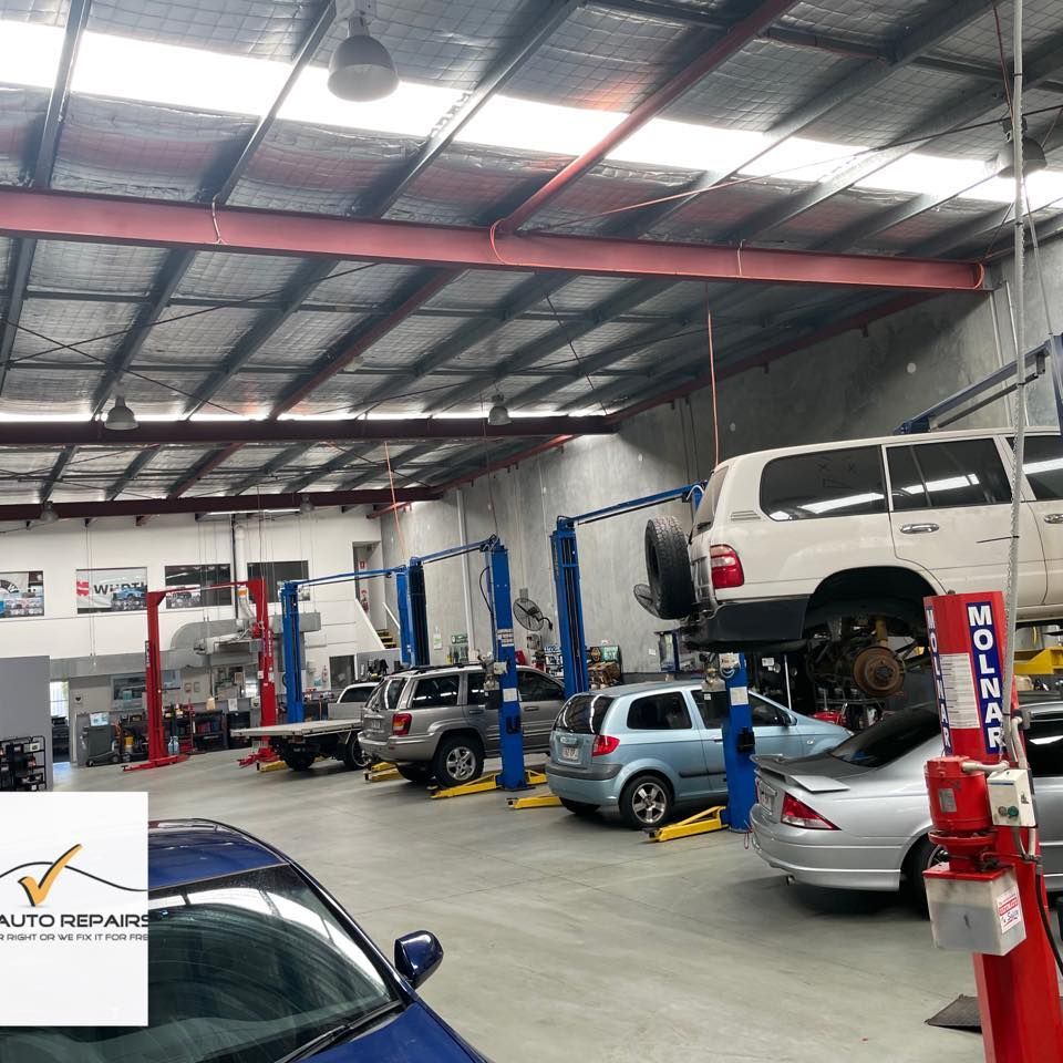 A row of cars in a garage with a sign that says auto repair β Carite Auto Repairs In Warana, QLD