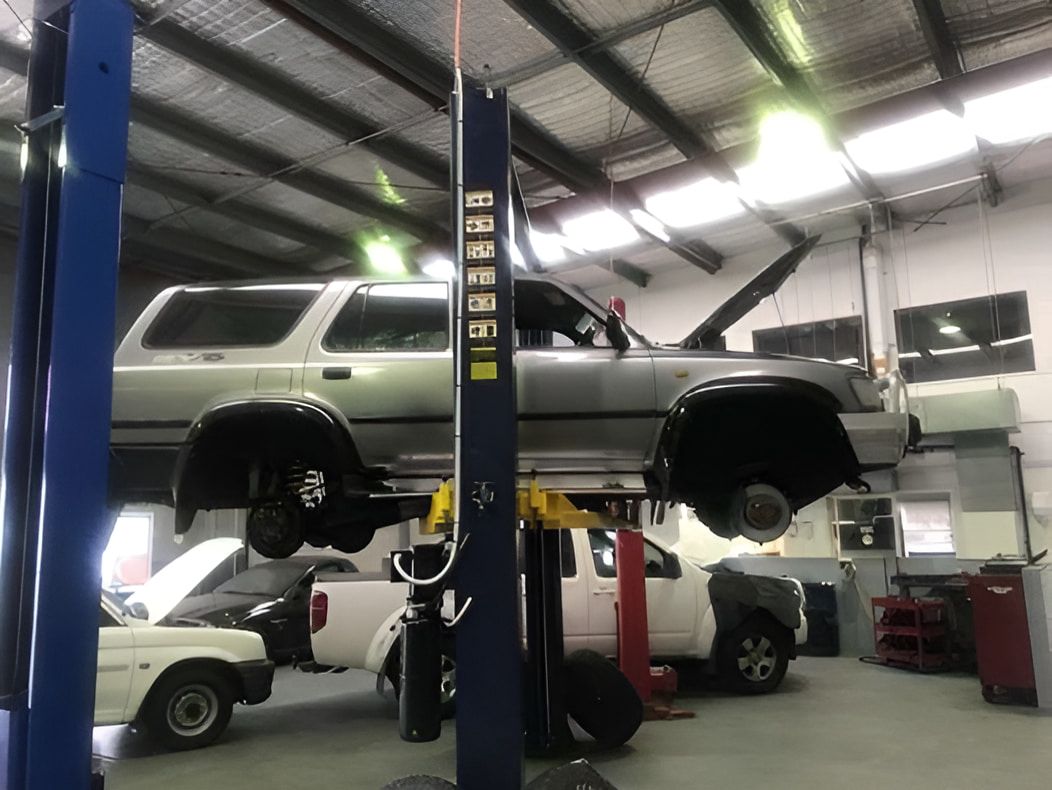 A Car Is Sitting On A Lift In A Garage — Carite Auto Repairs In Warana, QLD