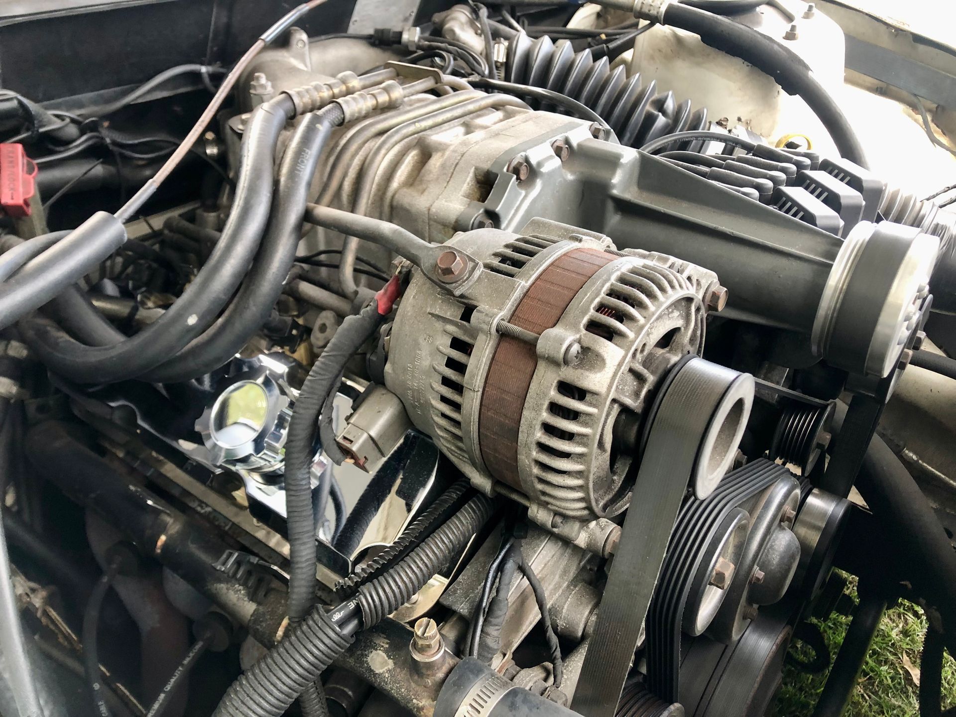 Car Engine With Visible Alternator, Belts, Hoses, and Metal Components — Carite Auto Repairs In Warana, QLD