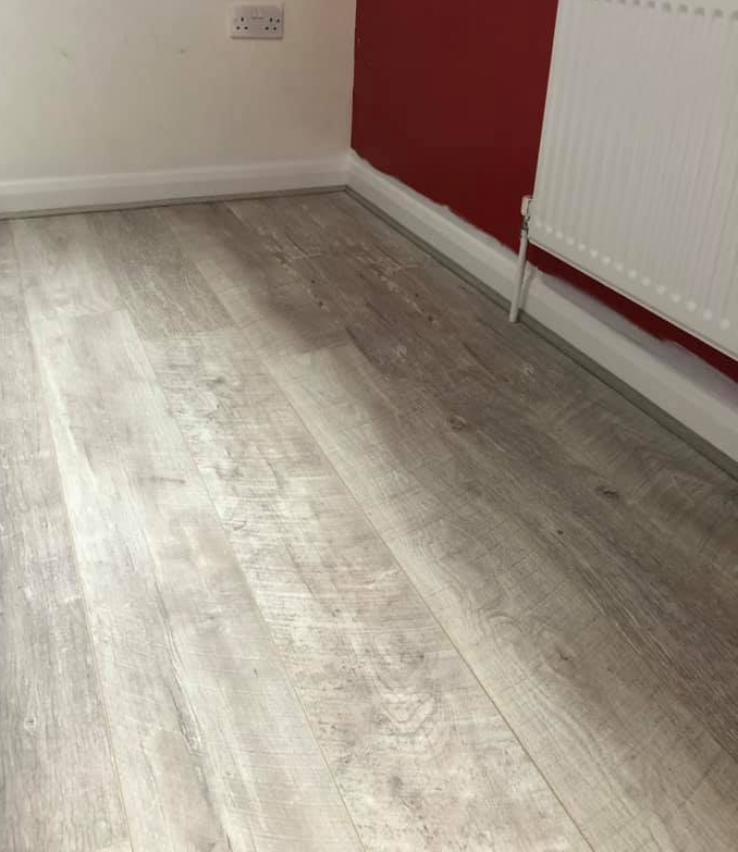 Grey wood effect laminate flooring fitted in a Nottingham lounge