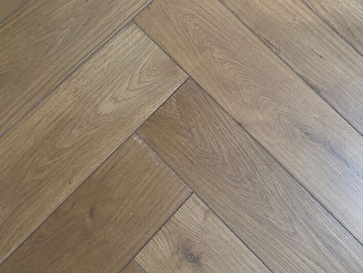 Close up of herringbone flooring showing the 90 degree block pattern
