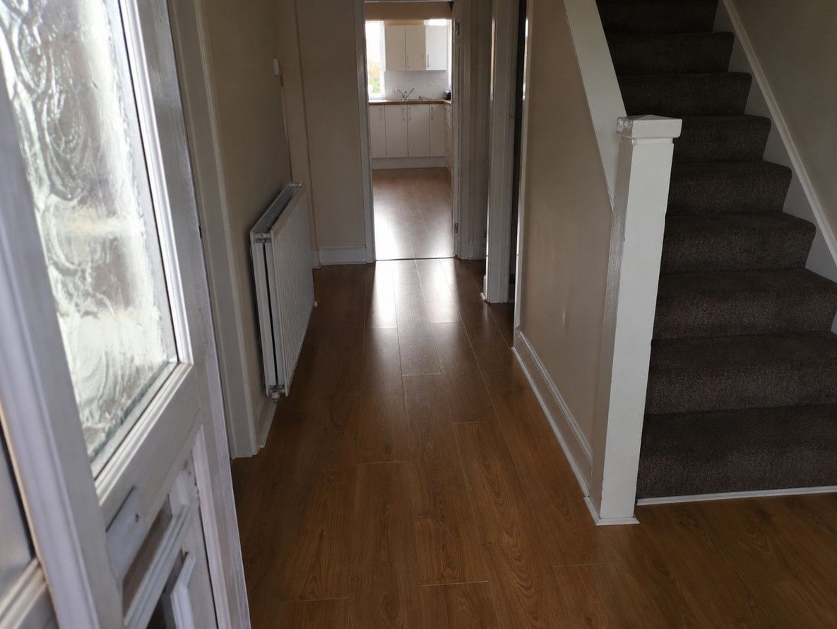 Wood-effect laminate flooring fitted in a West Bridgford hallway
