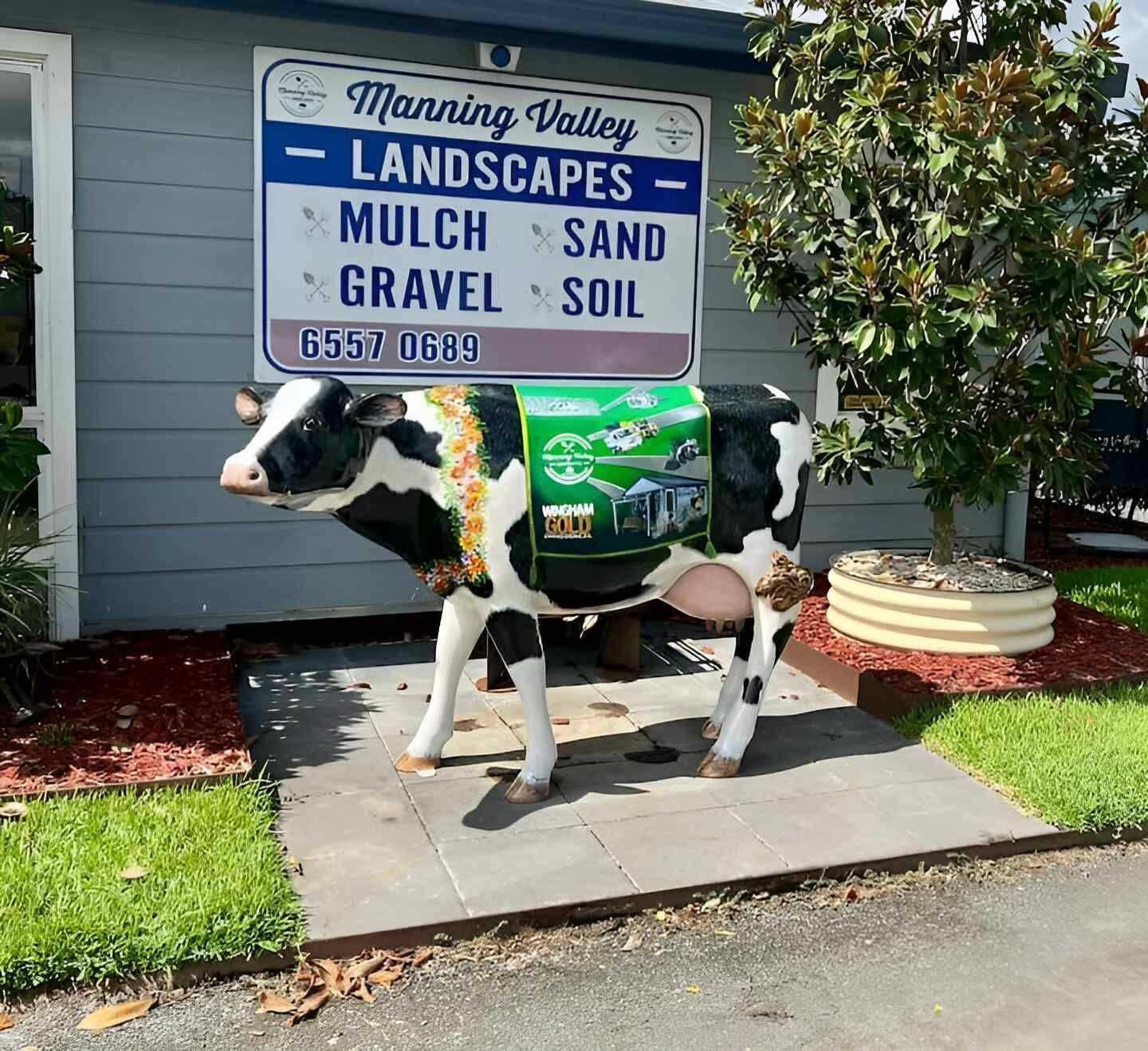 A Statue of a Cow in Front — Manning Valley Landscapes in Wingham, NSW