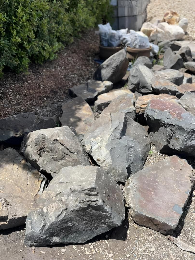 A pile of rocks sitting on top of each other on the ground. — Manning Valley Landscapes in Coolongolook, NSW