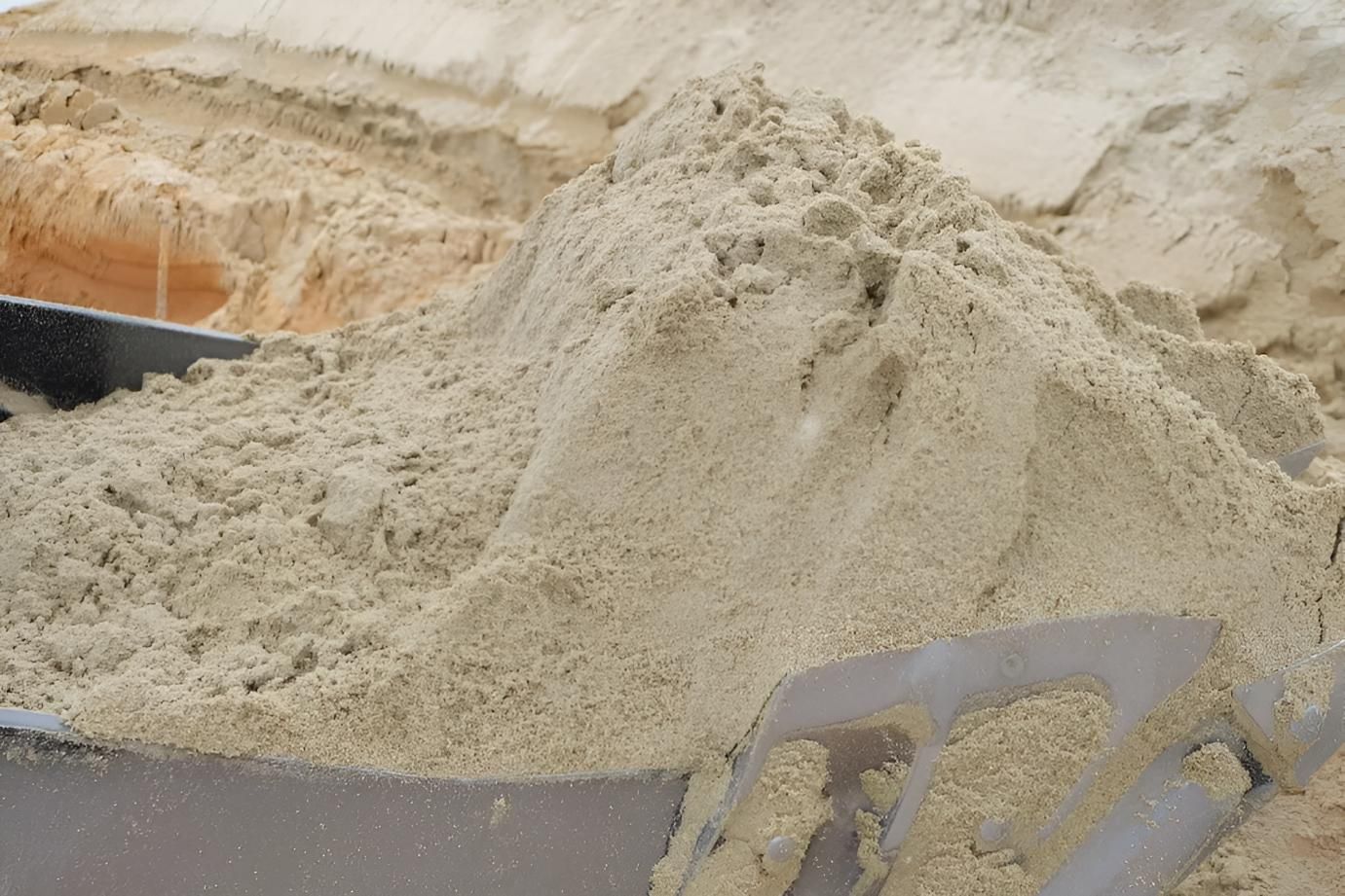 A Pile of Sand is Being Poured Into a Shovel — Manning Valley Landscapes in Harrington, NSW