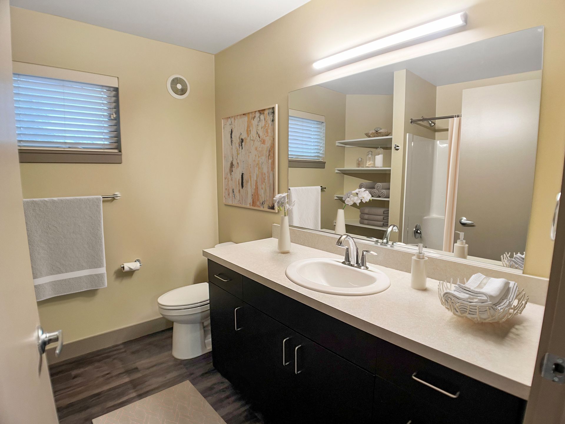 A bathroom with a sink , toilet , and mirror.