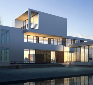 Modern white building with large windows reflecting sunlight.