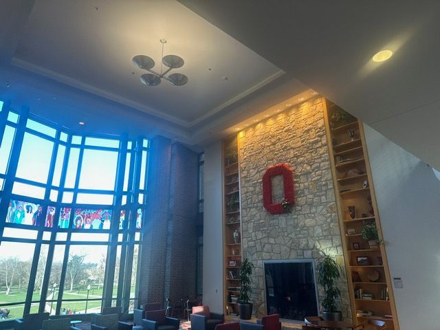 A living room with a fireplace and a large window