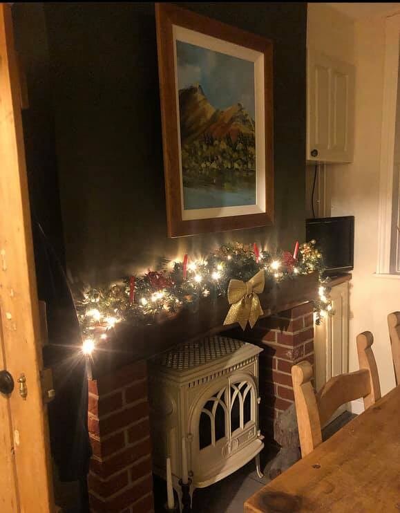 A room with a fireplace and a picture on the wall