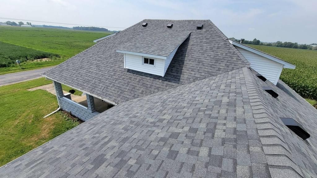 An aerial view of a house with a gray roof.