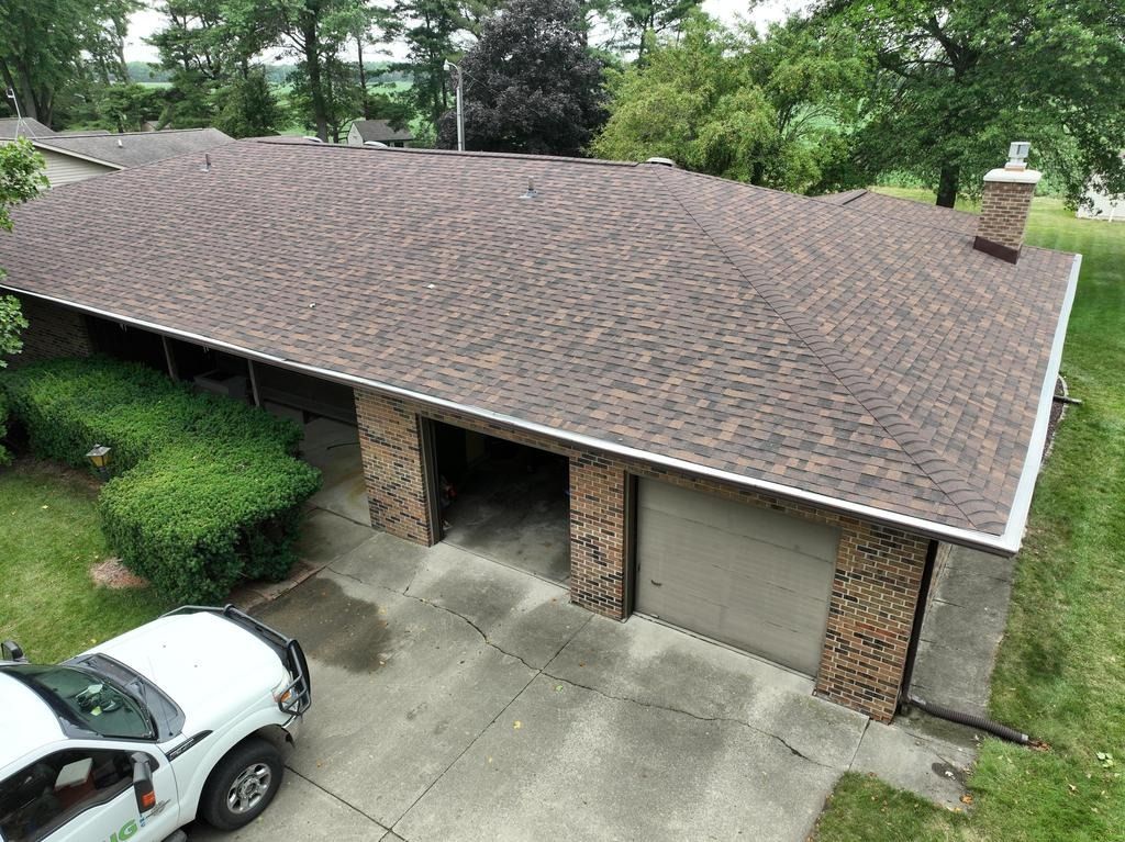 An aerial view of a house with a car parked in front of it.