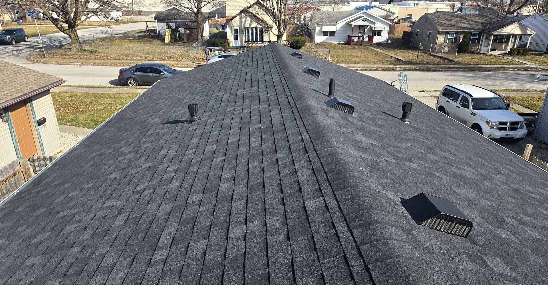 A roof with a lot of shingles on it in a residential area.