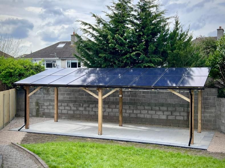A carport with solar panels on the roof.
