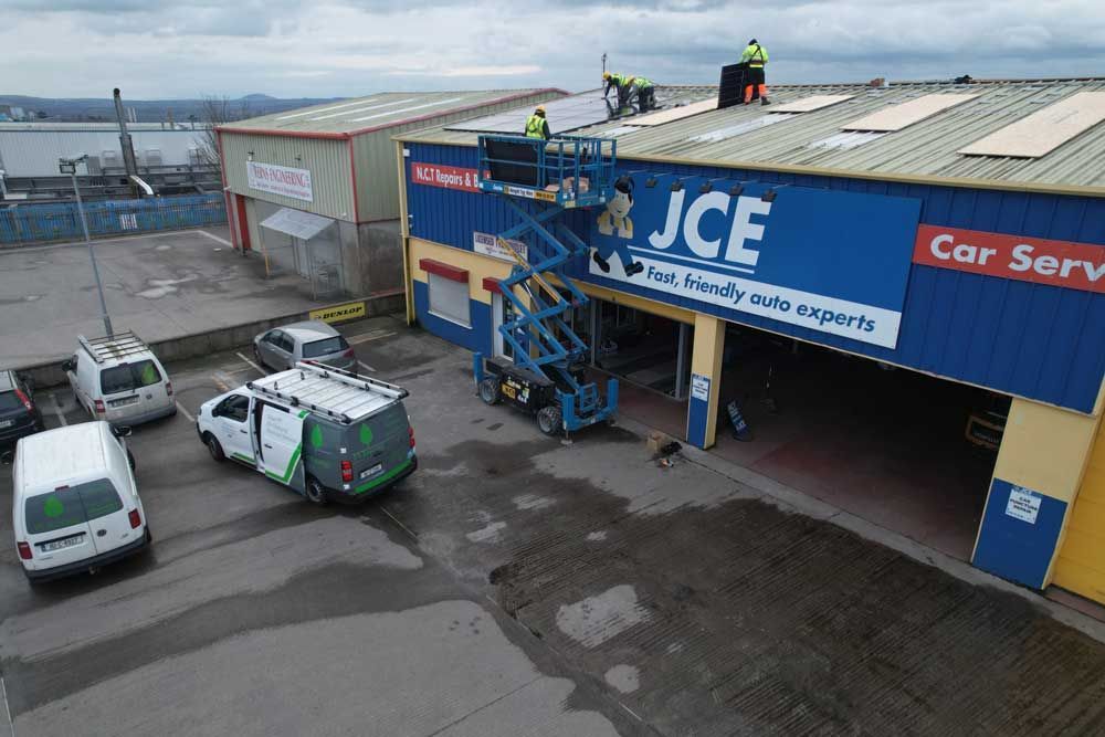 A group of people are working on the roof of a building.