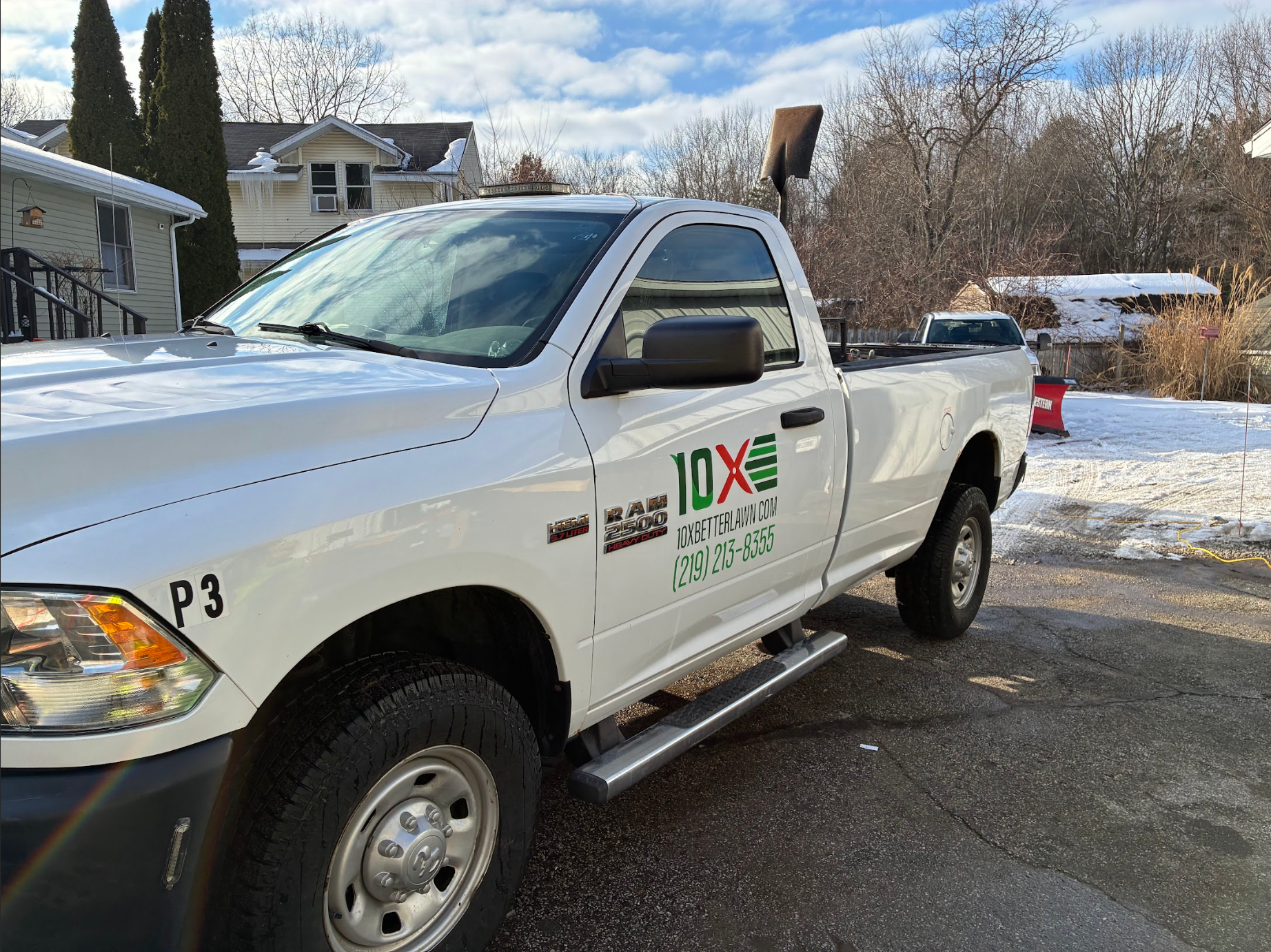 lawn maintenance hobart in White utility pickup truck parked on a snowy street with company logo on the door