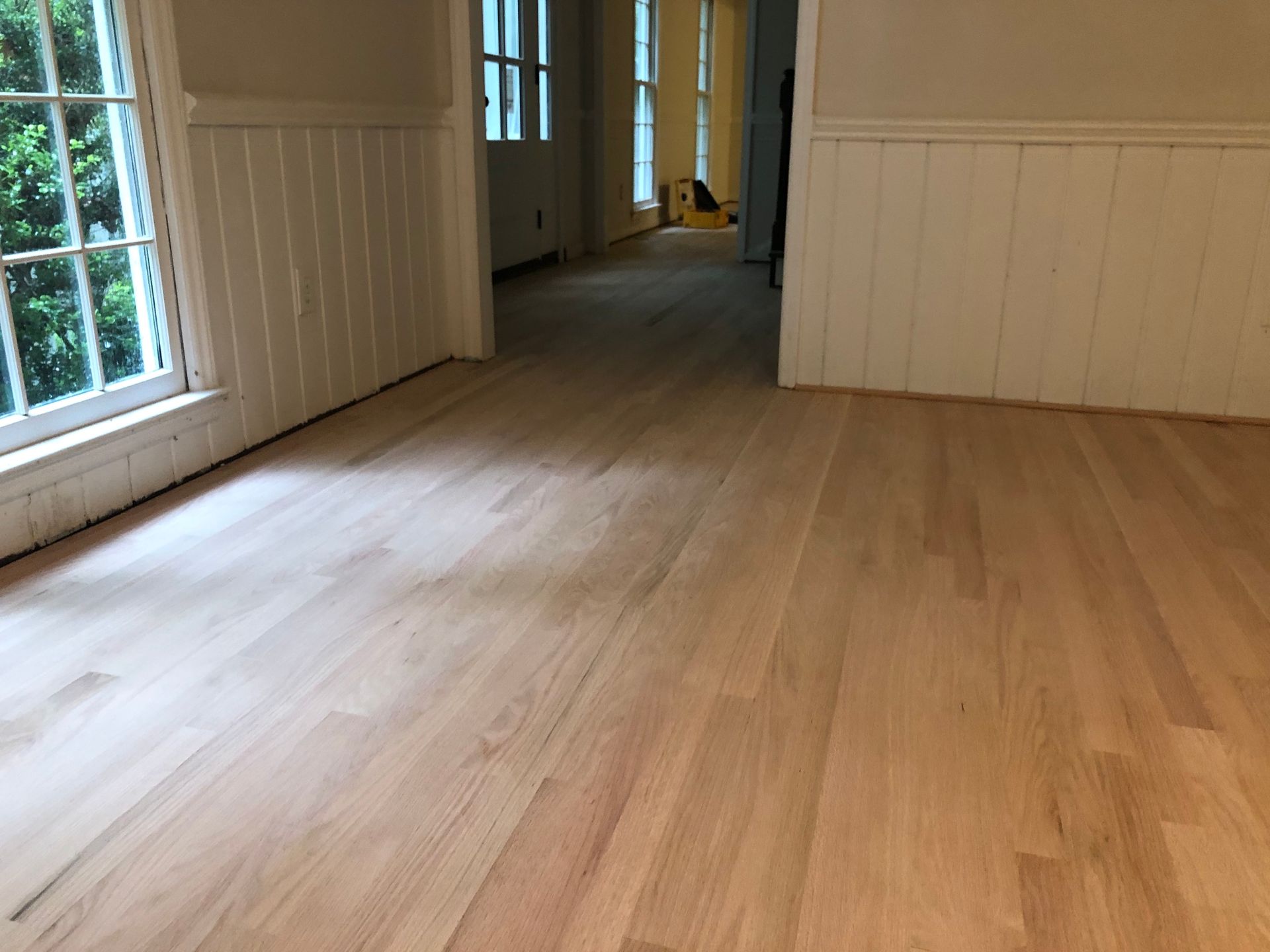 A room with a wooden floor and a window